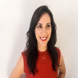 Jessica Barkley – BTA Luxury Travel Advisor Jessica Barkley, luxury travel advisor at Boutique Travel Advisors, smiling in a red dress against a white background.